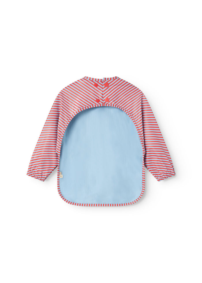 Apron with long sleeves in blue and red stripes and a light blue front panel.