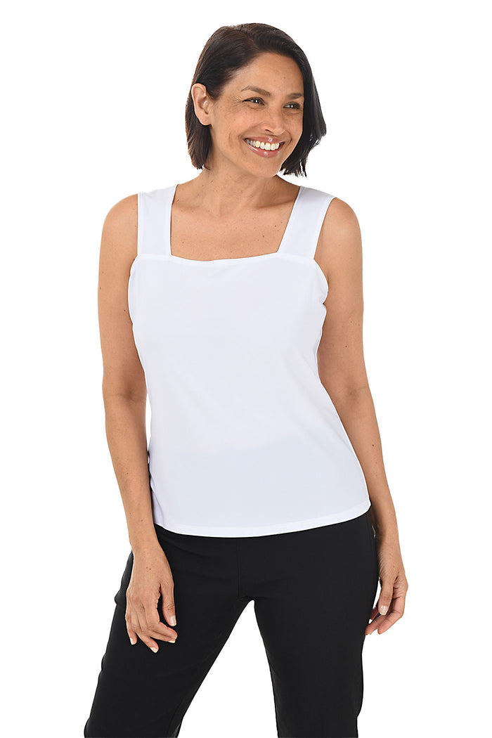 A woman wearing a white square neckline tank top with straight hem, paired with black pants.