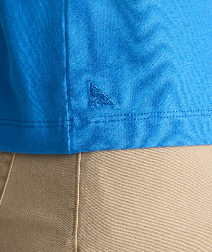 Model is wearing UNTUCKit EcoSoft Short-Sleeve Henley in light blue.