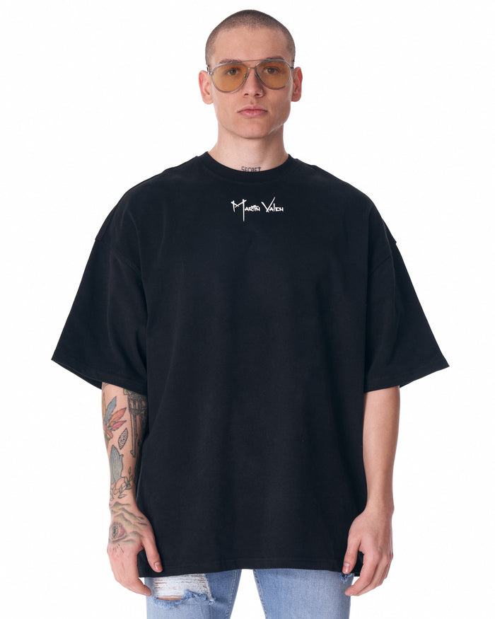 Martin Valen black half-sleeve T-shirt, front cropped view showing white centered logo and oversized fit