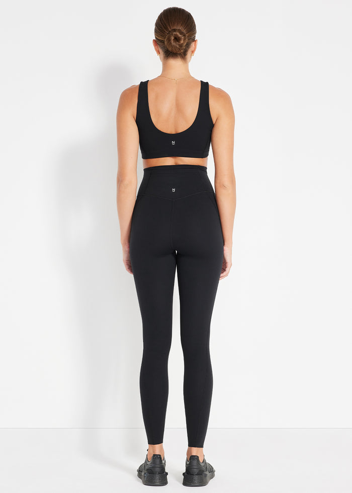 Back view of black scoop bra and bike shorts designed for a smooth, supportive fit