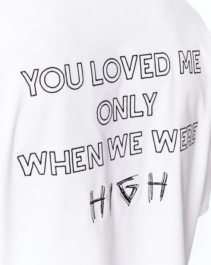 Loved Me Text Print Oversized White T-Shirt paired with washed denim