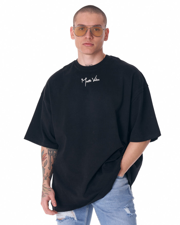 Martin Valen men's black half-sleeve T-shirt, front view on model showing centered white logo and relaxed fit