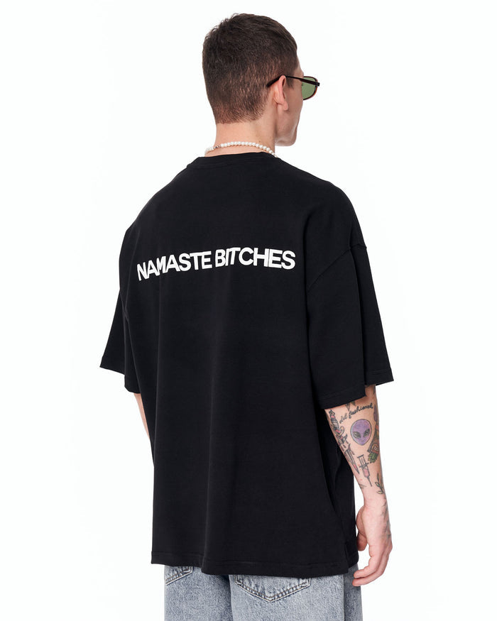 Namaste Streetwear Oversized Black T-Shirt paired with washed denim jeans