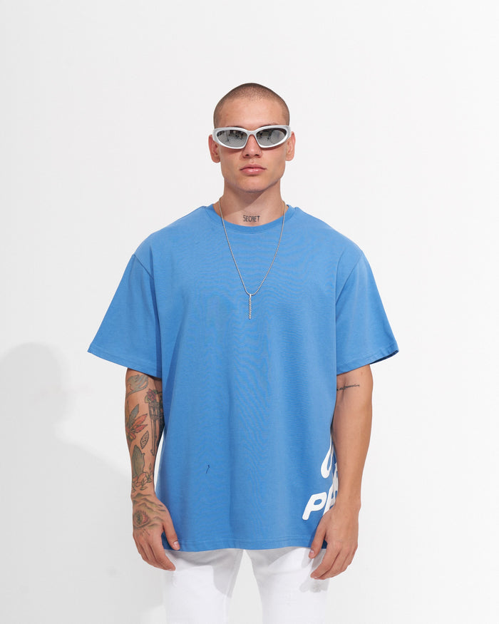 Martin Valen 'Perspective' oversized men's blue T-shirt, full back view highlighting large white wavy puff print