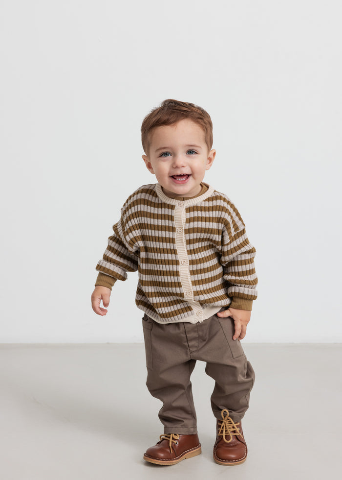 Children wearing khaki pants and striped cardigan