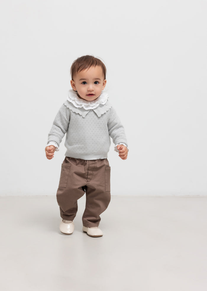 Children wearing khaki pants and gray knit blouse