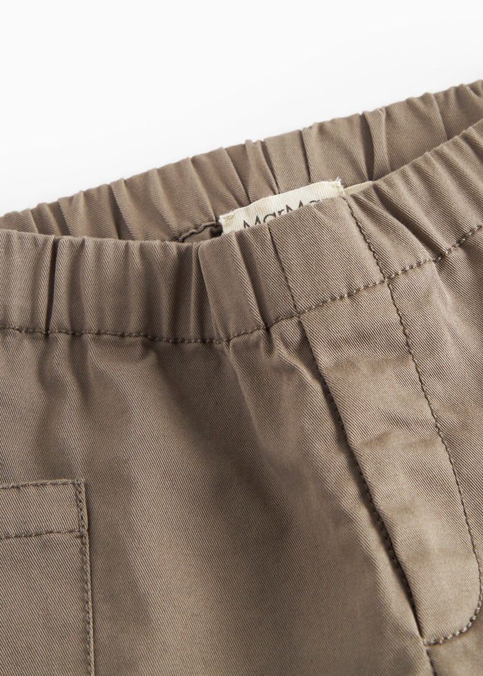 Close-up of khaki pants with visible seams and elastic waist