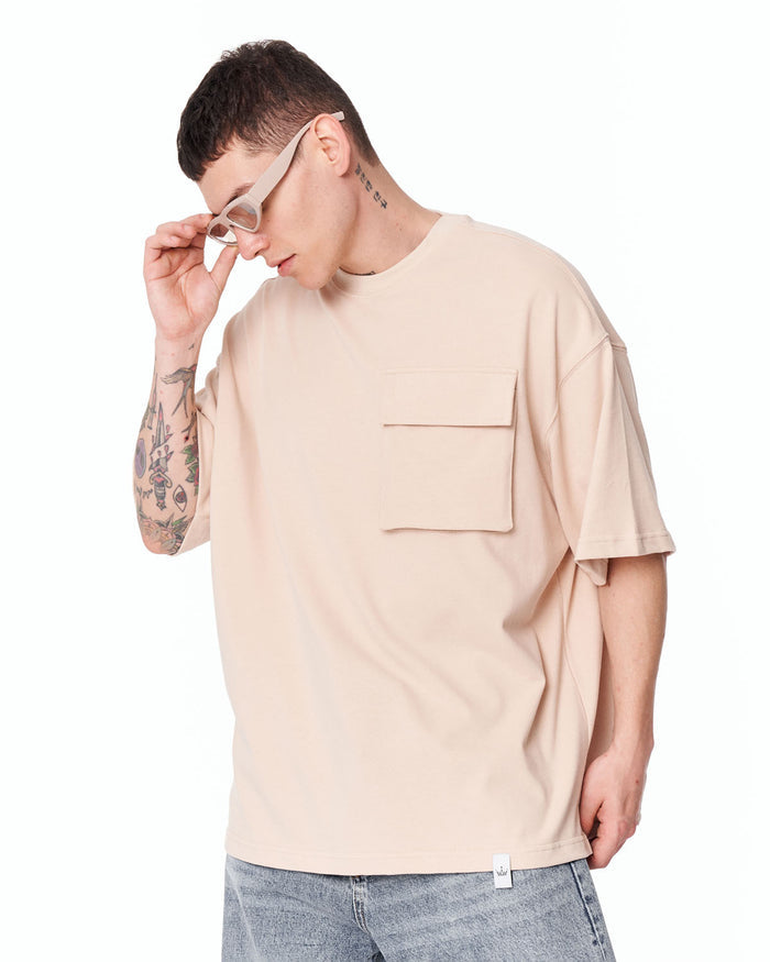 Utility Pocket Oversized Beige T-Shirt paired with blue denim jeans
