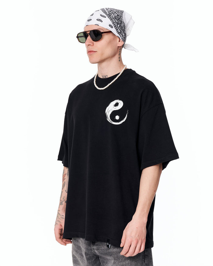 Yin Yang Brush Graphic Oversized Black T-Shirt styled with washed grey denim