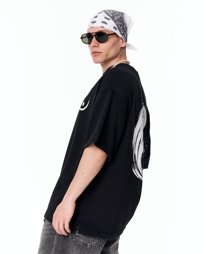 Yin Yang Brush Graphic Oversized Black T-Shirt paired with dark grey jeans